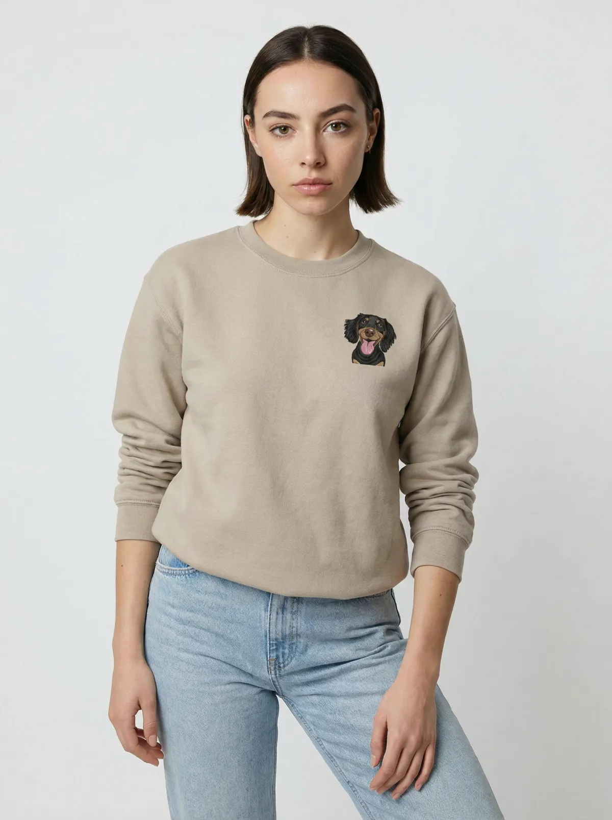 The Sand crewneck being worn, with an example embroidered pet on the chest