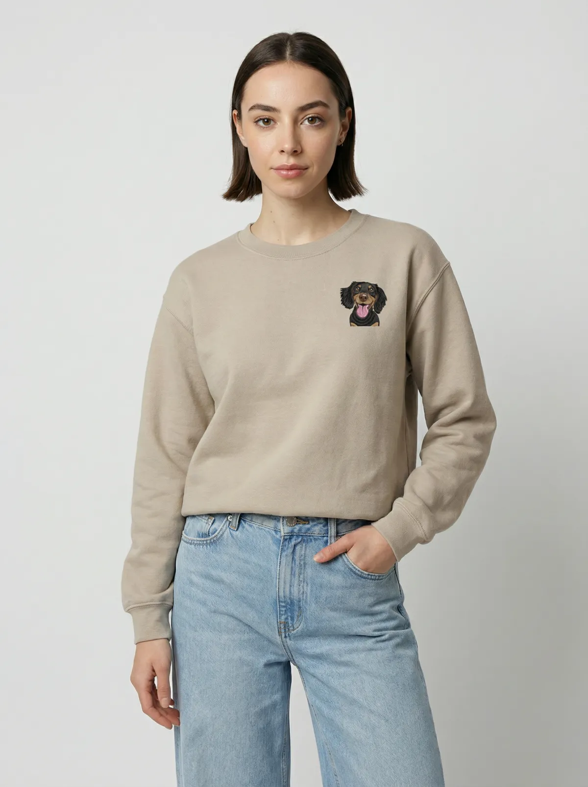 The Sand crewneck being worn, with an example embroidered pet on the chest