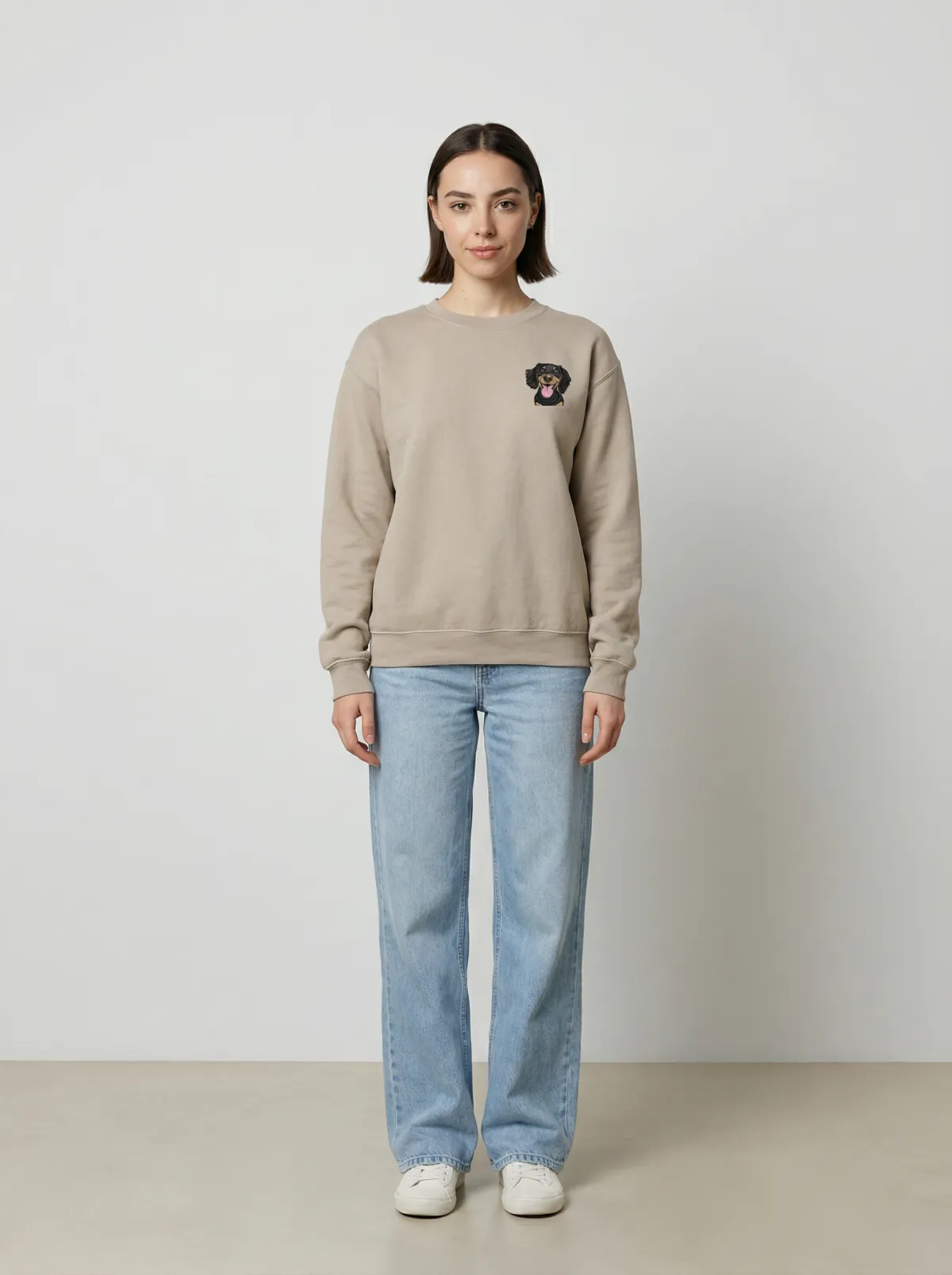 The Sand crewneck being worn, with an example embroidered pet on the chest